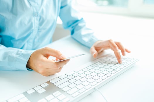 Female hands using computer and credit card on it photo