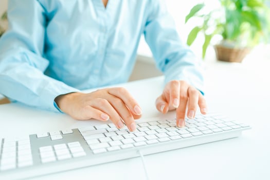 Woman office worker typing on the keyboard photo
