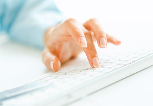 Woman office worker typing on the keyboard photo