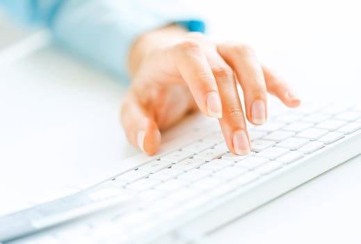 Woman office worker typing on the keyboard photo