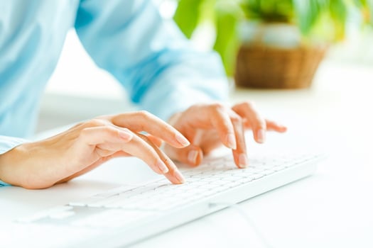 Woman office worker typing on the keyboard photo
