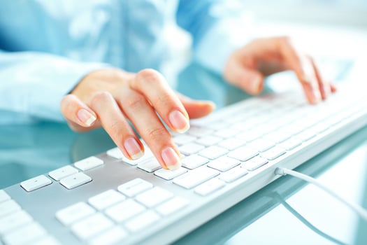 Woman office worker typing on the keyboard photo