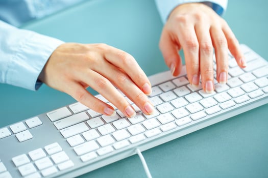 Woman office worker typing on the keyboard photo