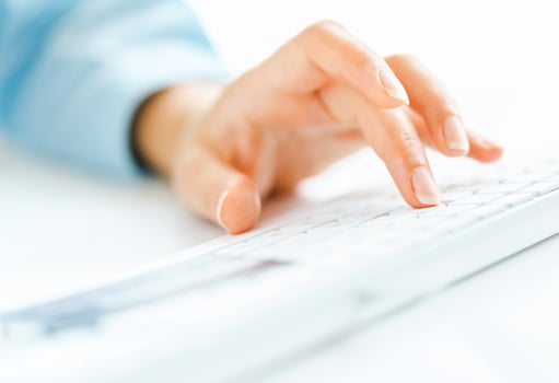 Woman office worker typing on the keyboard photo