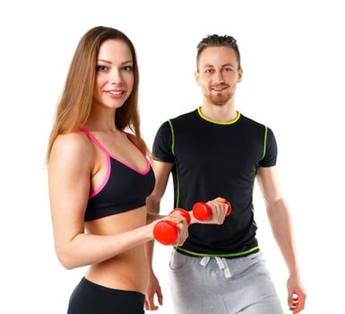 Athletic man and woman with dumbbells on the white photo