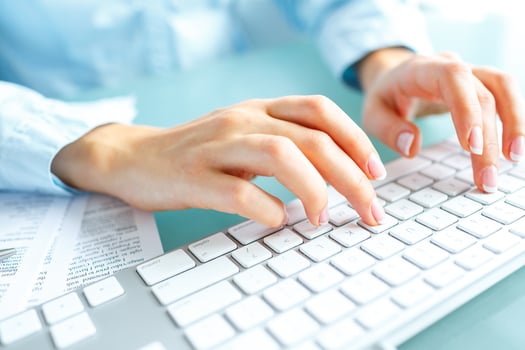 Woman office worker typing on the keyboard photo