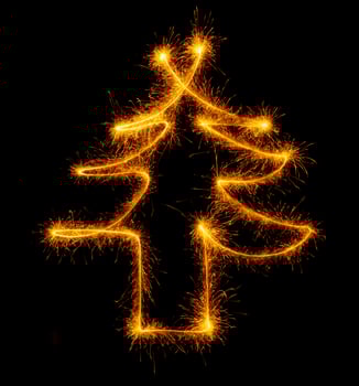 Christmas tree made by sparkler on a black photo