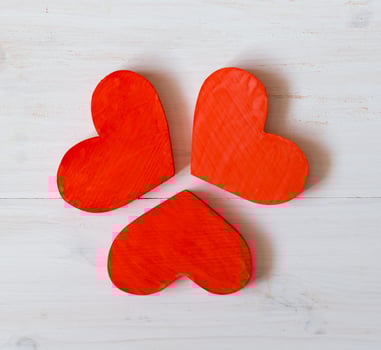 Red hearts on white wooden background photo