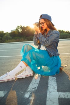 Young modern woman with skateboard photo