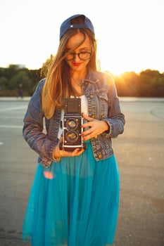 Young modern woman with vintage camera photo