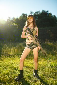 Young female soldier with machine gun photo
