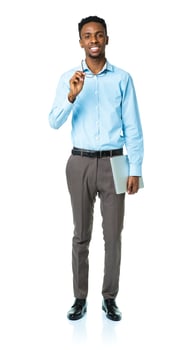 Happy african american college student standing with laptop on white photo