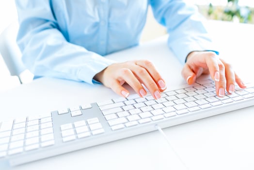 Woman office worker typing on the keyboard photo