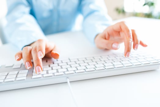 Woman office worker typing on the keyboard photo
