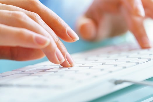 Woman office worker typing on the keyboard photo