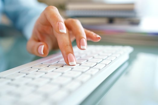 Woman office worker typing on the keyboard photo
