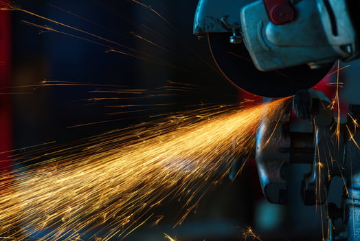 Angular grinding machine is cutting the metal and a lot of sparks photo