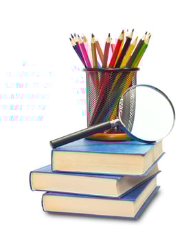 The book, pencils, and magnifying glass photo