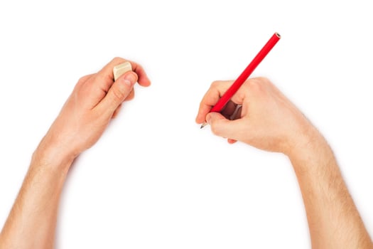Human hands with pencil and erase rubber writting something photo