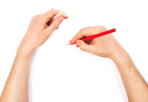 Human hands with pencil and erase rubber writting something photo