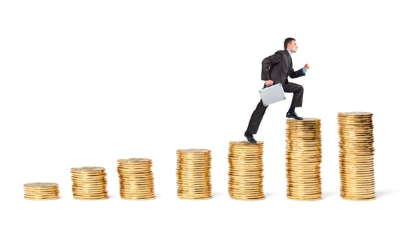 Businessman goes up the gold coins photo