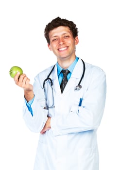 Portrait of a smiling male doctor holding green apple on white photo