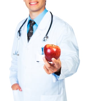 Doctor holding red apple on white close-up photo