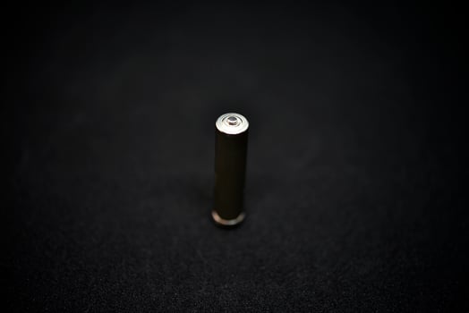 A shiny electric battery on a black background. The battery is a close-up. photo