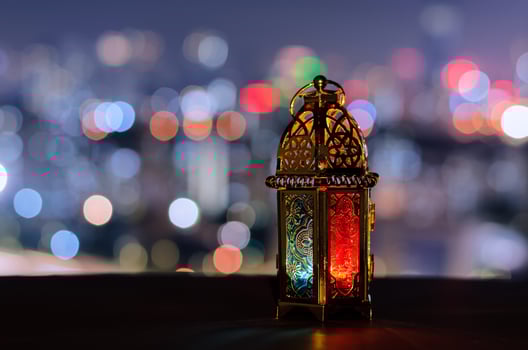 Lantern with night sky and city bokeh light background for the Muslim feast of the holy month of Ramadan Kareem. photo