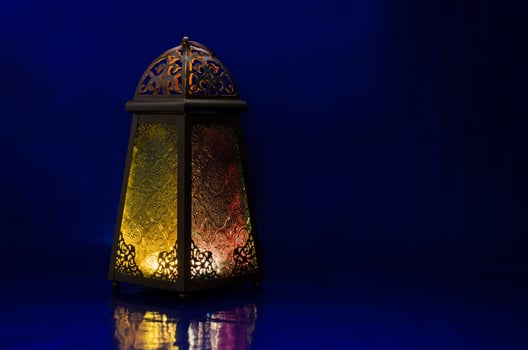Lantern puts on table with dark blue background for the Muslim feast of the holy month of Ramadan Kareem. photo