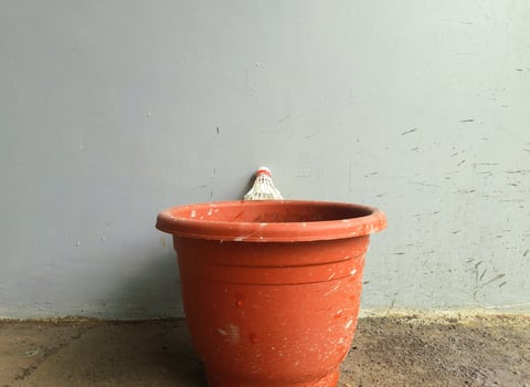 Red Pot and Shuttlecock, Abandoned Red Pot with a Shuttlecock on Top photo