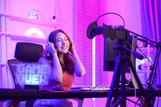 Young Asian Pretty woman Pro Gamer have live streaming , singing  and chatting  with her fans  at home photo