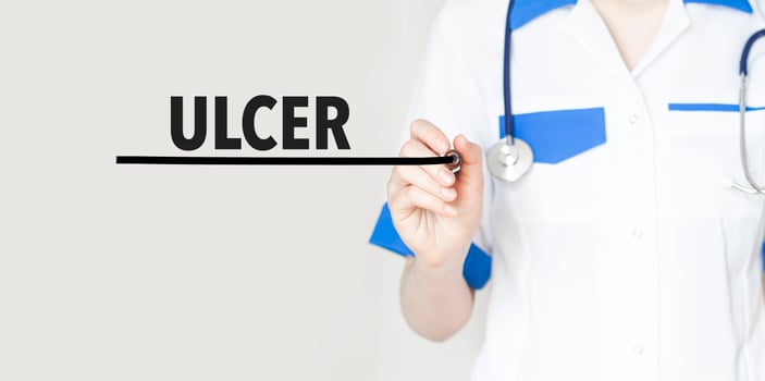 Doctor writing text ulcer with marker, medical concept photo