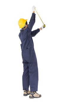Young worker in unifrom with tape measure on white photo