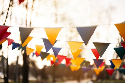 Colorful triangular flags against sunset sky. photo