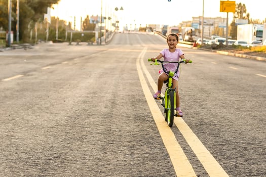 Cute little girl learning ride a bicycle. Spring summer autumn active sport leisure for kids. Toddler kid on bike photo