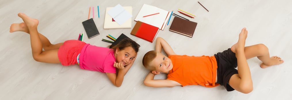 Two children, little girls of preschool age watching tablet at home on the floor photo