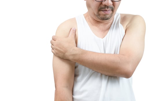 A middle aged man in white veat suffering from arm and shoulder pain isolated photo