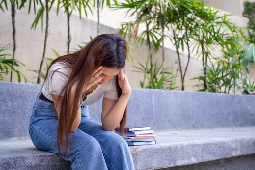 An Asian schoolgirl is sitting disappointed and worried about the unexpected test scores. photo