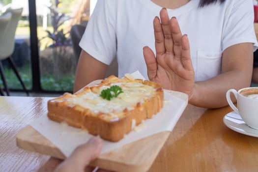 Beauty slim female body confuse desserts. Woman in restaurant achieves weight loss goal for healthy life, crazy about thinness, thin waist, nutritionist. Diet, body shape. photo