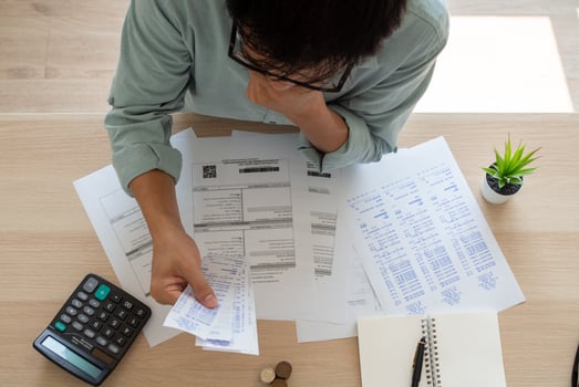 Business men are experiencing debt problems sitting stressful on your desk with a lot of documents and bills. Concept of debt photo