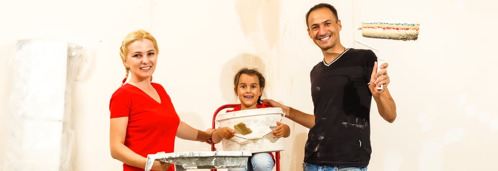 Young family doing painting job during home renovation photo