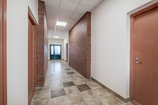 white empty long corridor with red brick walls in interior of modern apartments, office or clinic photo