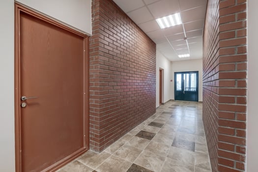 white empty long corridor with red brick walls in interior of modern apartments, office or clinic photo