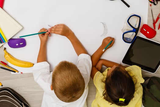 Two children, little girls of preschool age watching tablet at home on the floor photo