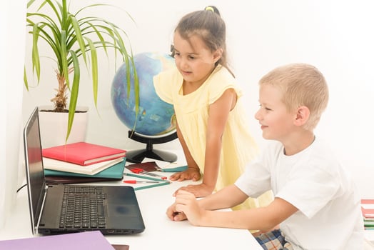 Boy and girl using a laptop at school. photo