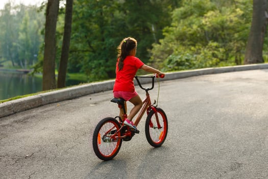 Girl on a bicycle spring morning photo