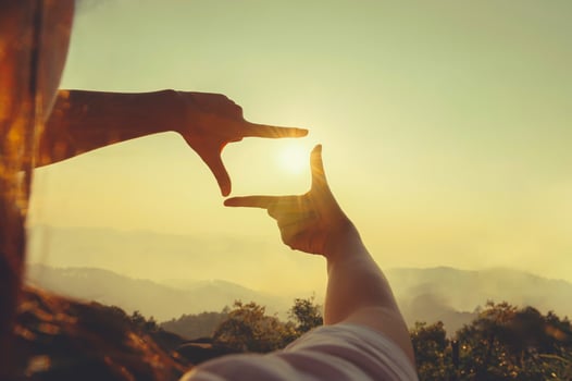 close up hand framing looking view sunrise photo