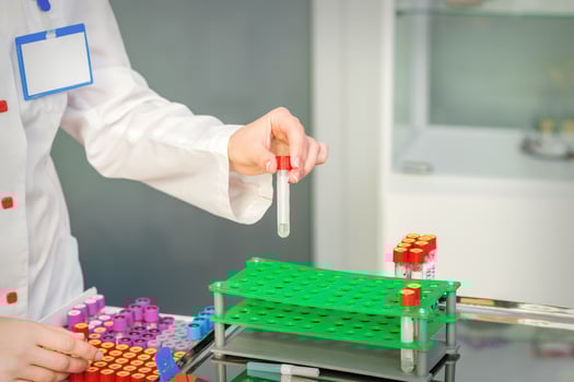 Nurse takes empty blood test tube photo