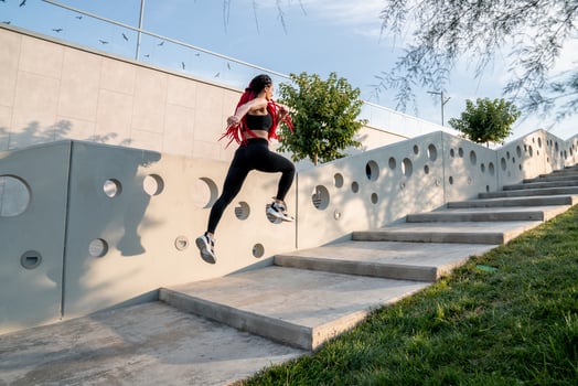 Fit young woman jumping and running photo